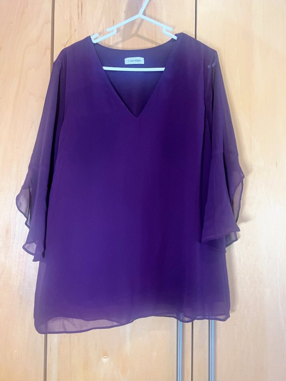 Calvin Klein top with beautiful drape and tulip hem sleeves, size M